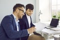 Two happy young business people doing professional paperwork in the company office Royalty Free Stock Photo