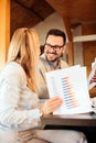 Two happy young business people having a meeting in a cafe Royalty Free Stock Photo