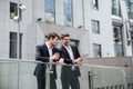 Two happy young businessmen discussing project and using tablet Royalty Free Stock Photo