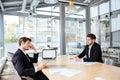 Two happy young businessmen working together on business meeting Royalty Free Stock Photo