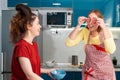 Two happy young Caucasian women cook in the kitchen and have fun together. Indoors. Concept of joint home cooking for LGBT couples Royalty Free Stock Photo