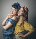 Two happy young female friends in retro clothing