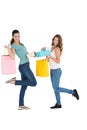 Two happy young female friends with shopping bags Royalty Free Stock Photo