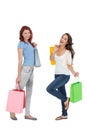 Two happy young female friends with shopping bags Royalty Free Stock Photo