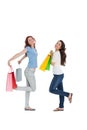 Two happy young female friends with shopping bags Royalty Free Stock Photo