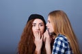 Two happy young girlfriends telling secrets. Girl Royalty Free Stock Photo