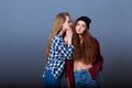 Two happy young girlfriends telling secrets. Girl Royalty Free Stock Photo