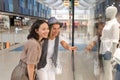 Two happy young girlfriends walking in shopping mall Royalty Free Stock Photo