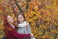 Two happy young girls at bright autumn background Royalty Free Stock Photo