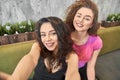 Two happy young girls doing selfie together. Royalty Free Stock Photo