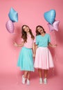 Two happy young girls dressed in bright colorful clothes Royalty Free Stock Photo