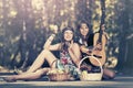 Two young fashion girls with fruit baskets in summer forest Royalty Free Stock Photo