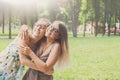 Two happy young girls hug each other in summer park Royalty Free Stock Photo