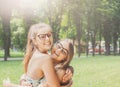 Two happy young girls hug each other in summer park Royalty Free Stock Photo