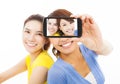 Two happy young girls taking a selfie over white Royalty Free Stock Photo