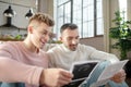 Two happy young men looking at pictures of ultrasound.