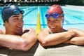 Ready for another lap. Two happy young swimmers standing in the pool smiling at the camera. Royalty Free Stock Photo