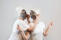 Two happy young woman apply clay mask on face enjoy free time Royalty Free Stock Photo