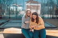 Two happy young woman friends having fun on city street.Taking selfie, using the smart phone. Krakow, Poland Royalty Free Stock Photo