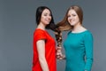 Two happy young women made one brair with their hair