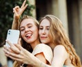 Two happy young women together taking a selfie in the city. Summer day. Friendship concept. Royalty Free Stock Photo