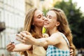 Two happy young women together taking a selfie in the city. Summer day. Royalty Free Stock Photo