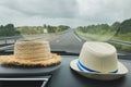 Two hats in the car Rural landscape outside the window Royalty Free Stock Photo