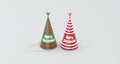 Two Hats With Stripes and Text Merry Christmas on a Gray Background. Royalty Free Stock Photo