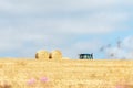 Haystacks in a field covered in the grass under a cloudy sky and sunlight- cool for wallpapers Royalty Free Stock Photo