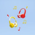 Two headphones and musical notes on blue background Royalty Free Stock Photo