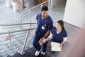 Two healthcare colleagues talking on the stairs at hospital Royalty Free Stock Photo