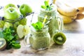 Two healthy green smoothies with spinach, banana, apple, kiwi and mint in glass jar and ingredients. Detox, diet, healthy, Royalty Free Stock Photo