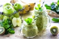 Two healthy green smoothies with spinach, banana, apple, kiwi and mint in glass jar and ingredients. Detox, diet Royalty Free Stock Photo