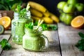 Two healthy green smoothies with spinach, banana, apple, kiwi and mint in glass jar and ingredients. Detox, diet, healthy, Royalty Free Stock Photo