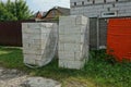 Two heaps of white blocks of bricks in transparent cellophane packaging