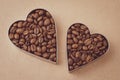 Two heart of coffee beans on brown background. Craft paper. Art design. Vintage parchment. Shape of heart, symbol of love. Heap of