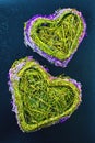 Two heart made from dried herbs and flowers on a blue background Royalty Free Stock Photo