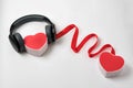 Two heart shape boxs, red ribbon and headphones on a white background. Connection hearts