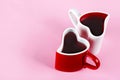 Two heart shape mugs on pink background. Valentine`s day concept