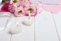 Two heart shaped burning candles and beautiful flowers on the white background Royalty Free Stock Photo