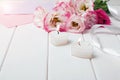 Two heart shaped burning candles and beautiful flowers on the white background Royalty Free Stock Photo