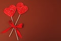 Two heart-shaped candies. Valentine`s day lollipops on brown background. Valentine`s day background, wedding day