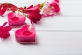 Two heart shaped candles on the white wooden table Royalty Free Stock Photo