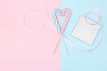 Two heart shaped candy canes with gift box on pastel blue and pink background. Sweet love, marriage proposal minimal concept Royalty Free Stock Photo