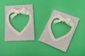 Two heart shaped canvas frame on green paper Royalty Free Stock Photo
