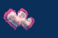 Two heart shaped clouds with pink green glitch effect against dark blue background. Valentine day and love greeting card with