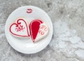 Two heart shaped cookies with a lipstick kiss and a plate on a gray marble counter Royalty Free Stock Photo