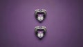 Two Heart-Shaped Diamonds on Purple Background Royalty Free Stock Photo