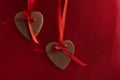 Two heart-shaped gingerbread cookies with red ribbons as decor. Mothers day. Womans day. Valentines day