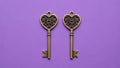 Two Heart-Shaped Keys on Purple Background Royalty Free Stock Photo